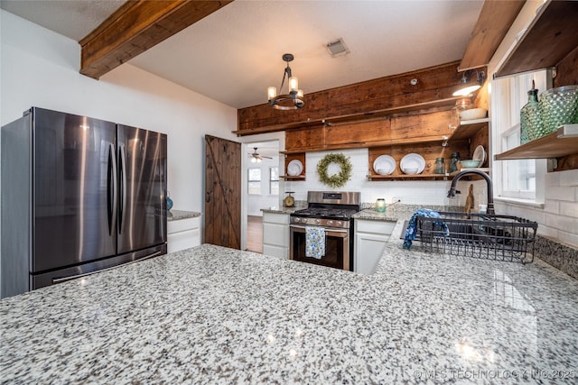 kitchen with light stone counters, white cabinetry, tasteful backsplash, appliances with stainless steel finishes, and beamed ceiling