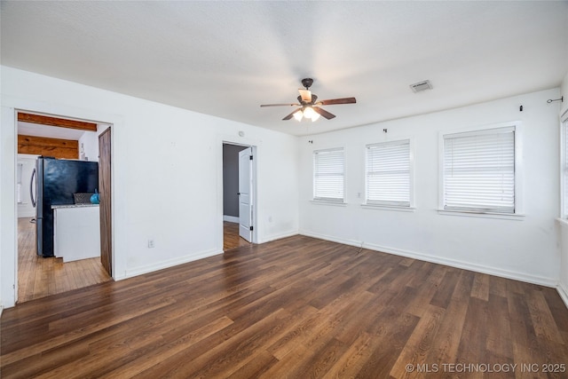 empty room featuring dark hardwood / wood-style floors and ceiling fan