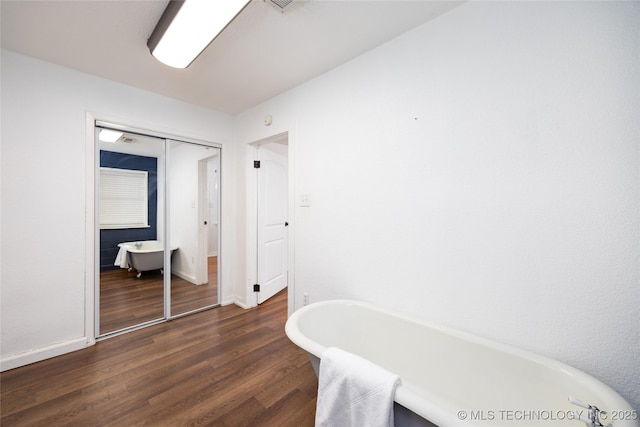 interior space featuring hardwood / wood-style floors and a bathtub