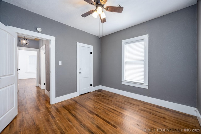 unfurnished bedroom with dark wood-type flooring and ceiling fan