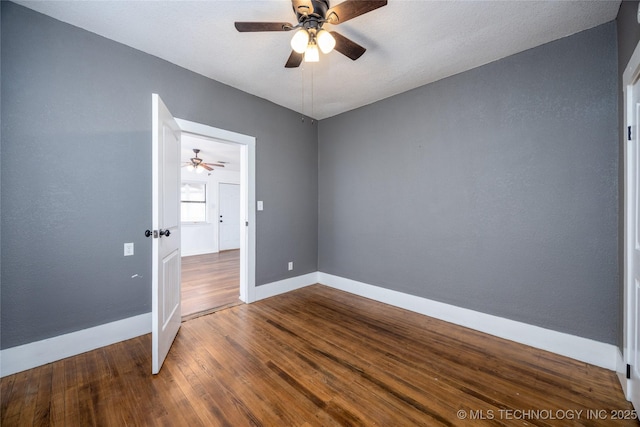 spare room with hardwood / wood-style flooring and ceiling fan