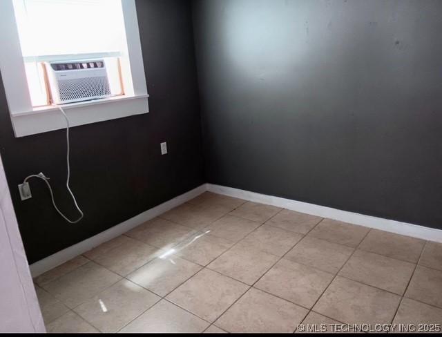 unfurnished room featuring cooling unit and light tile patterned floors