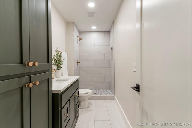 bathroom with tile patterned flooring, a shower stall, toilet, vanity, and visible vents