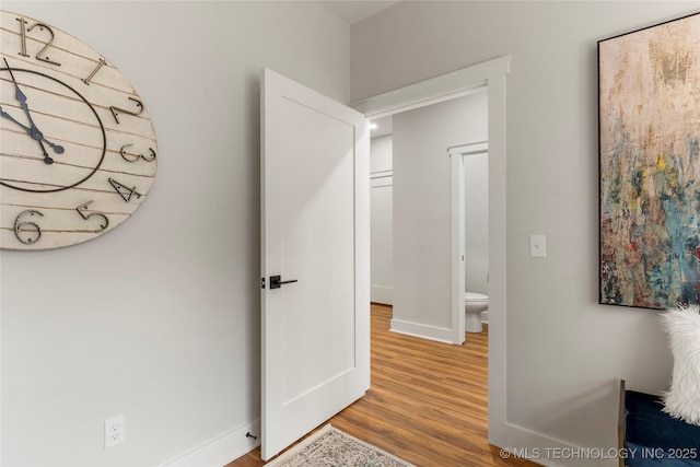interior space featuring wood finished floors and baseboards