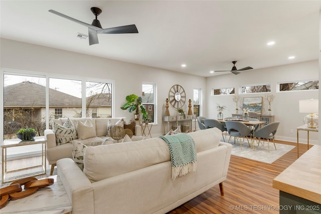 living area featuring wood finished floors, visible vents, a ceiling fan, and recessed lighting