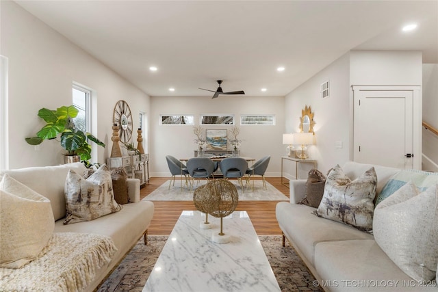 living area featuring recessed lighting, light wood-style floors, baseboards, visible vents, and a ceiling fan