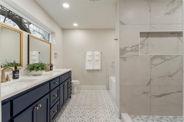 bathroom with baseboards, recessed lighting, toilet, and a sink
