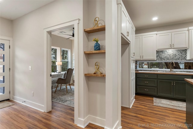 kitchen with baseboards, open shelves, decorative backsplash, and dark wood-type flooring