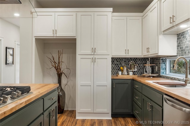 kitchen featuring dark wood-style floors, a sink, wood counters, and appliances with stainless steel finishes