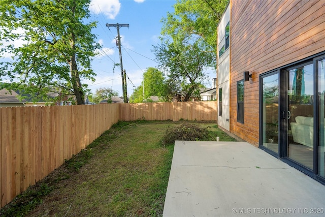view of yard featuring a patio area and a fenced backyard