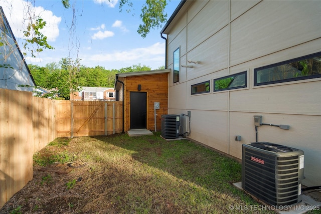 view of yard featuring fence and cooling unit