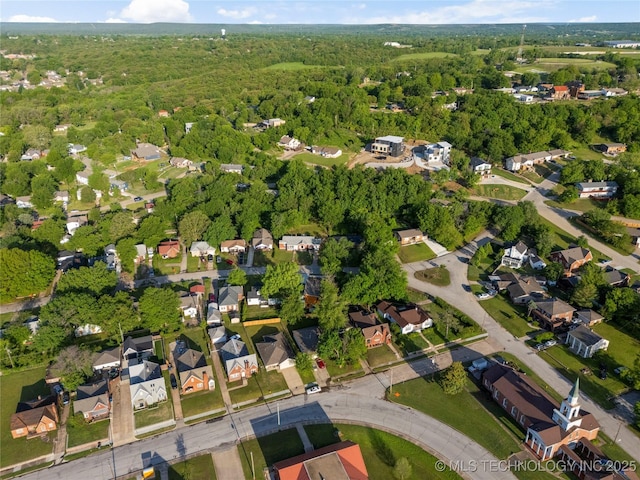 aerial view with a wooded view and a residential view