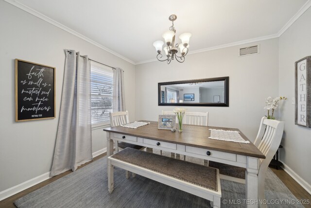 dining space featuring an inviting chandelier, crown molding, and dark hardwood / wood-style floors