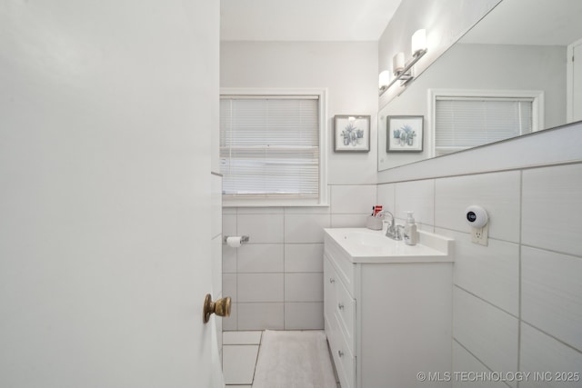 bathroom with tile walls and vanity