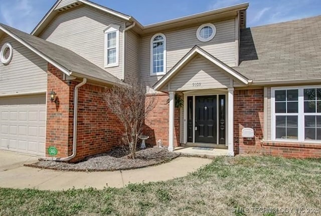 view of front facade with a garage and a front lawn