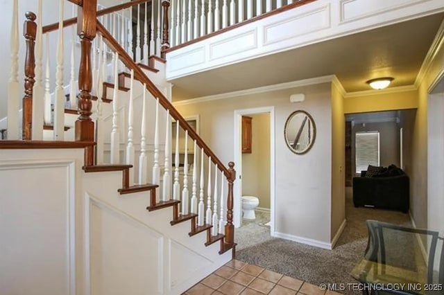 tiled foyer entrance with ornamental molding