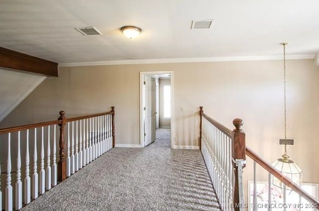 hall featuring lofted ceiling with beams, ornamental molding, and carpet