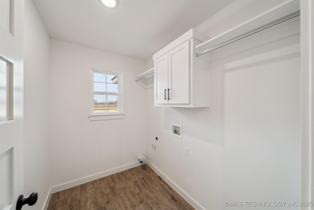 washroom featuring gas dryer hookup, cabinets, dark hardwood / wood-style floors, washer hookup, and hookup for an electric dryer