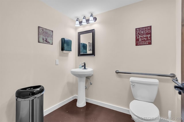 bathroom featuring toilet and concrete floors