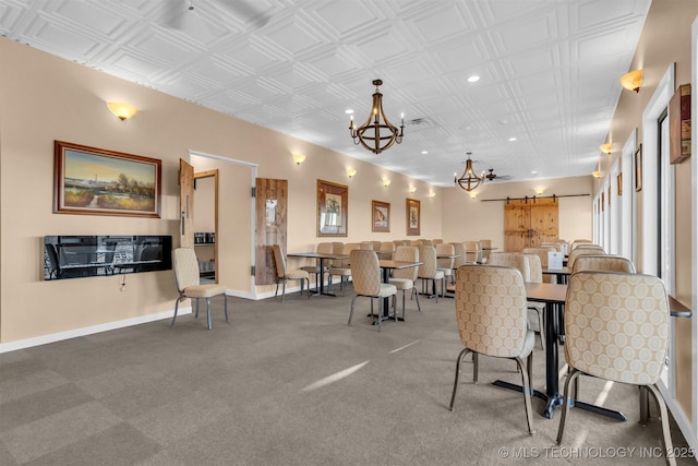 dining area with a notable chandelier and a barn door