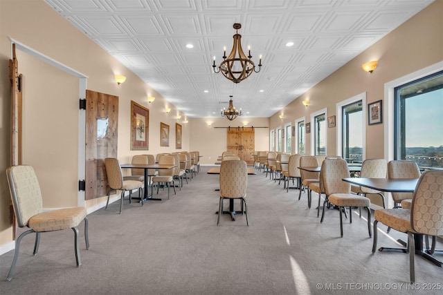 carpeted dining space with a chandelier