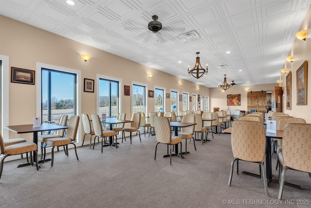 dining space with an inviting chandelier and a barn door