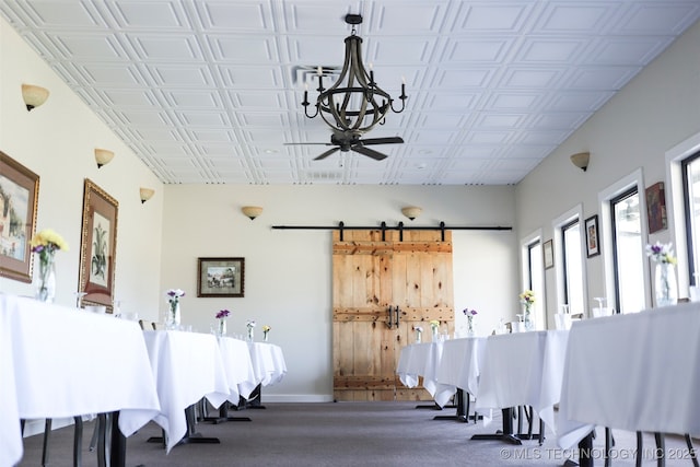 miscellaneous room with a barn door and ceiling fan