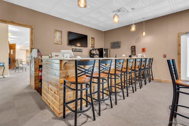 bar featuring decorative light fixtures and light carpet