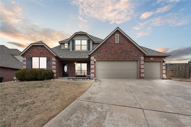 front facade with a garage and a lawn