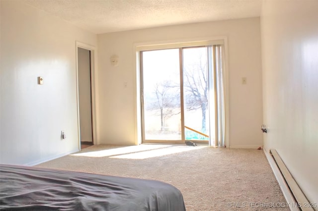 carpeted bedroom featuring a baseboard heating unit, access to outside, and a textured ceiling