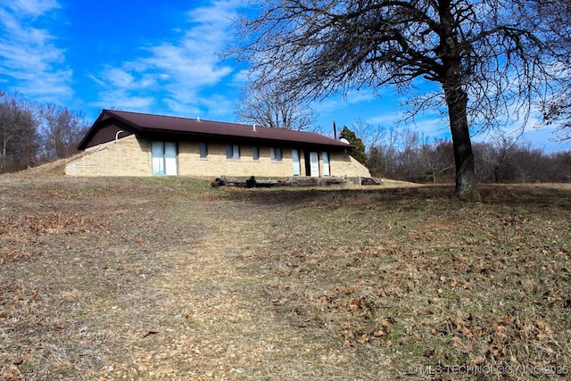 view of side of property with a lawn