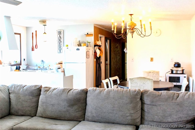 living room with sink and a notable chandelier