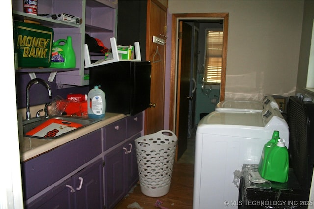 laundry area with sink, washer and clothes dryer, and hardwood / wood-style floors