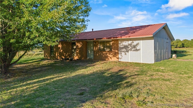 rear view of property with a yard