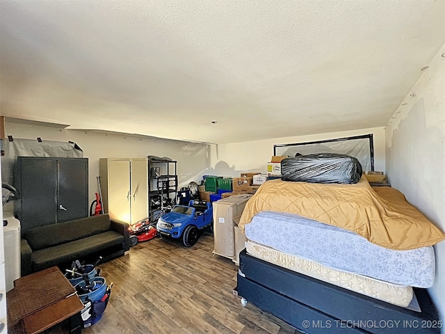 bedroom with wood-type flooring and a textured ceiling