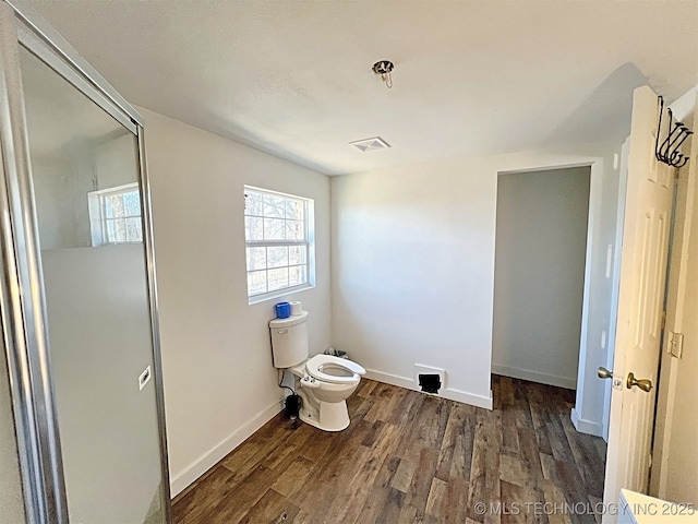 bathroom with hardwood / wood-style floors and toilet