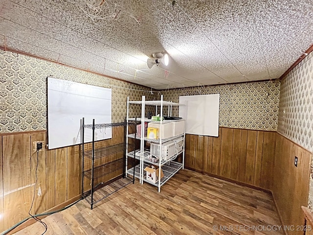 bedroom with hardwood / wood-style flooring and wooden walls