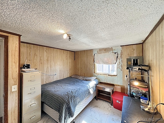 bedroom featuring wooden walls and a textured ceiling