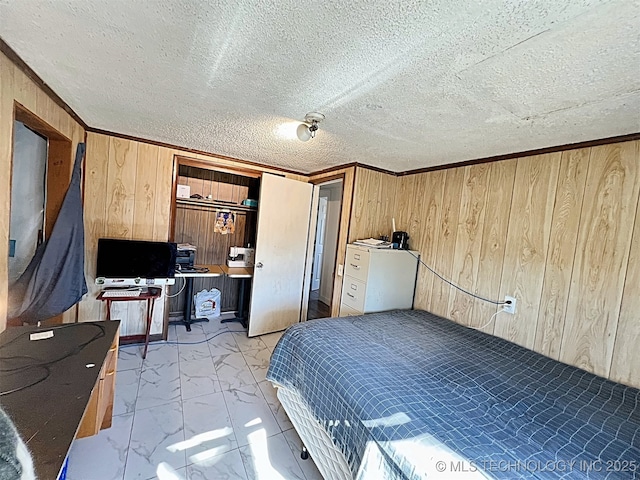 bedroom with crown molding, a closet, a textured ceiling, and wood walls