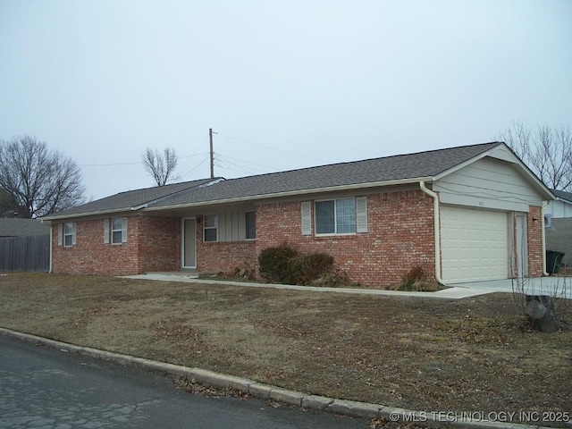 ranch-style house with a garage and a front lawn