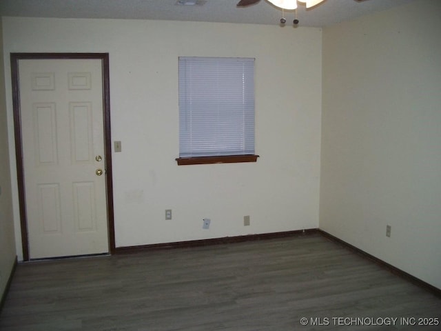 unfurnished room featuring ceiling fan and dark hardwood / wood-style flooring