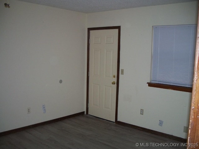 empty room featuring dark wood-type flooring