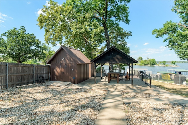 view of outdoor structure featuring a water view and a gazebo