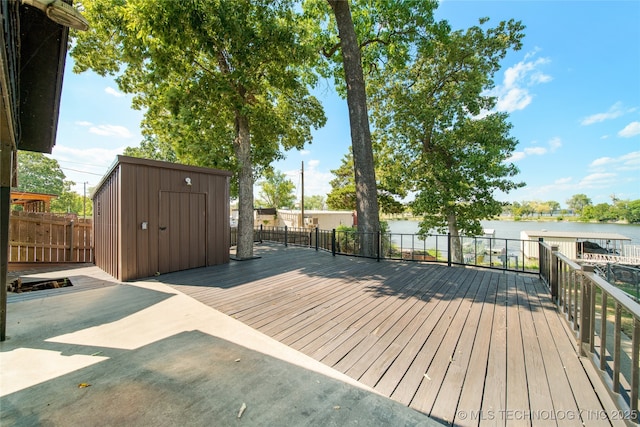 deck featuring a water view and a shed