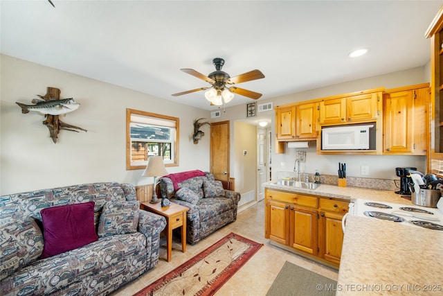 kitchen with ceiling fan, sink, and white appliances