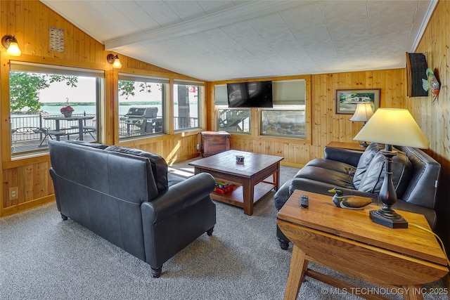 carpeted living room with lofted ceiling with beams and wooden walls