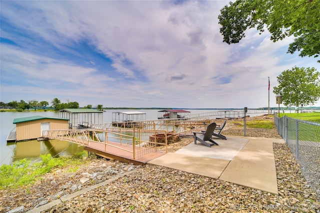 view of patio / terrace with a boat dock and a water view