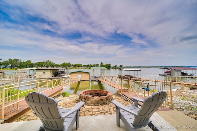 view of patio with a water view and a fire pit