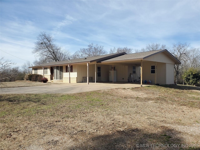 back of house featuring a lawn and a carport