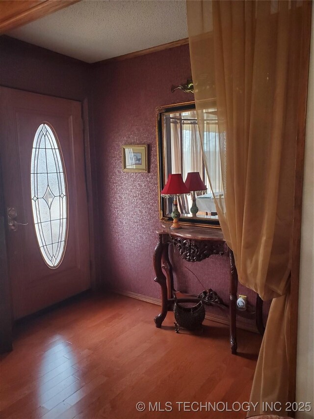 entryway featuring hardwood / wood-style floors and a textured ceiling